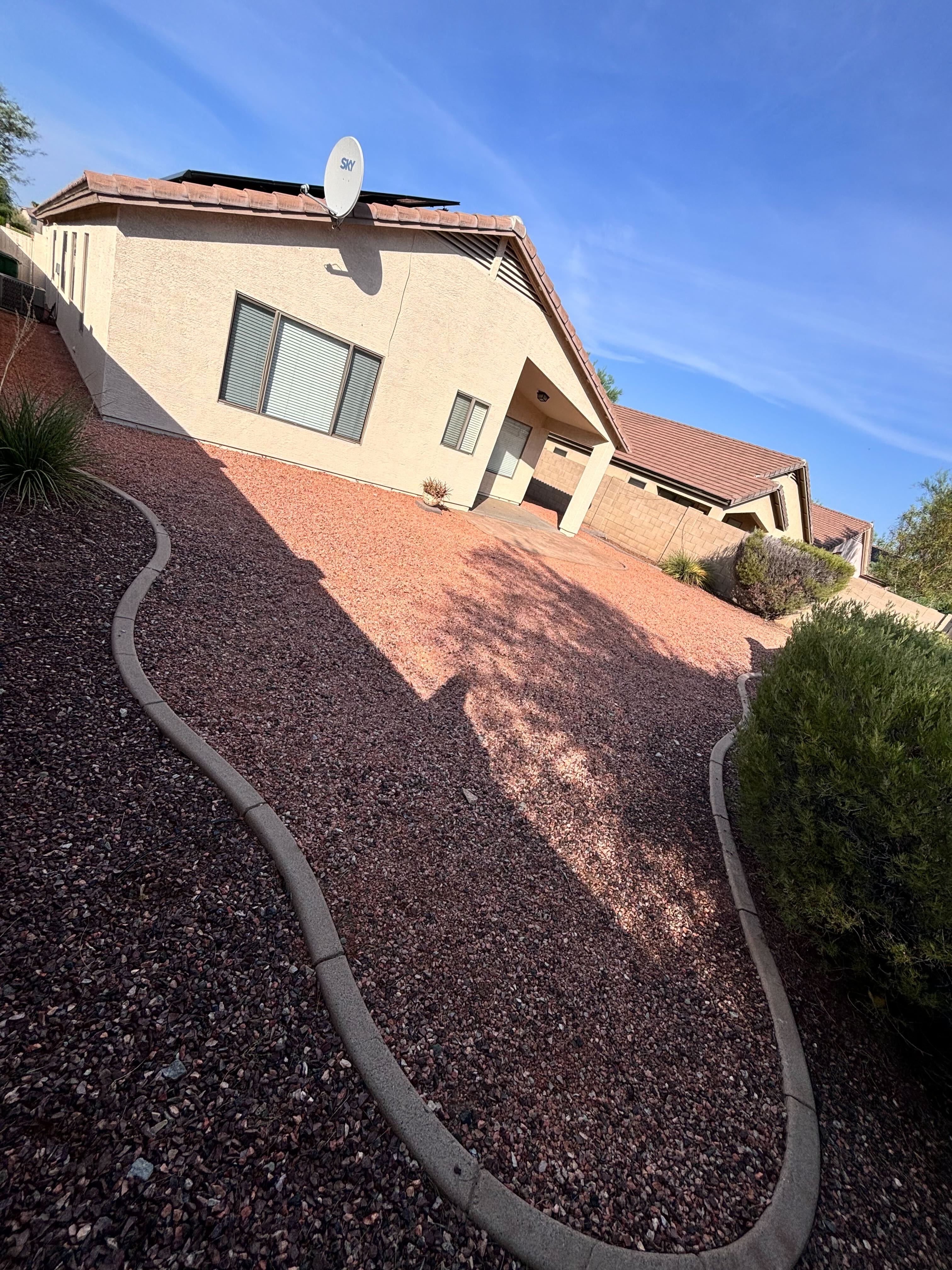 Backyard before artificial turf installation — bare Arizona dirt