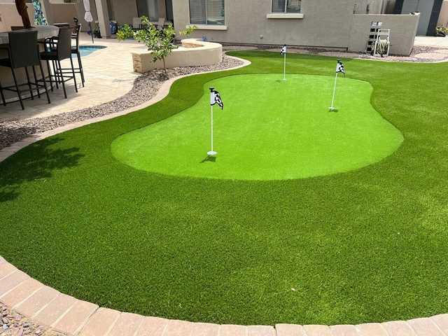 Backyard putting green with three flags installed in Arizona