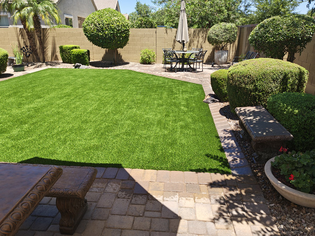 Arizona backyard combining artificial turf, paver patio and planted borders on almost no irrigation