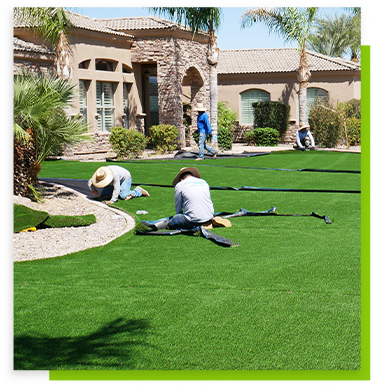 Workers custom fitting grass on the front lawn